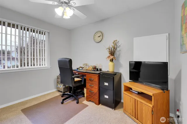 a view of workspace with furniture and flat screen tv