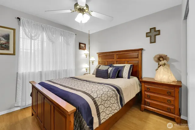 a bedroom with a bed and a chandelier