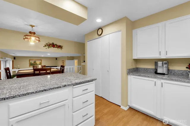 a kitchen with granite countertop a sink stainless steel appliances and cabinets