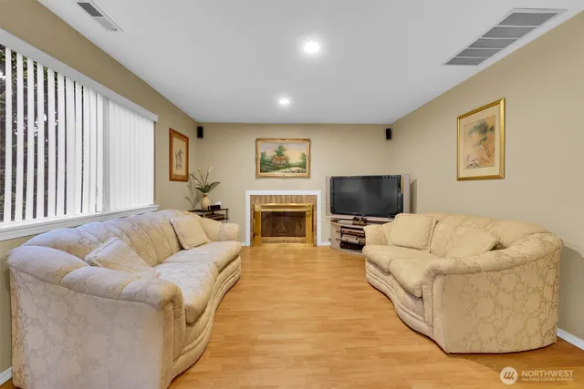 a living room with furniture fireplace and a flat screen tv