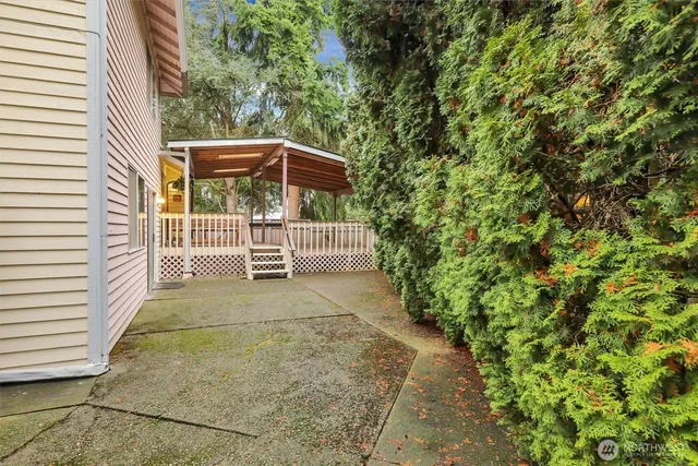 a view of a yard with plants and bench