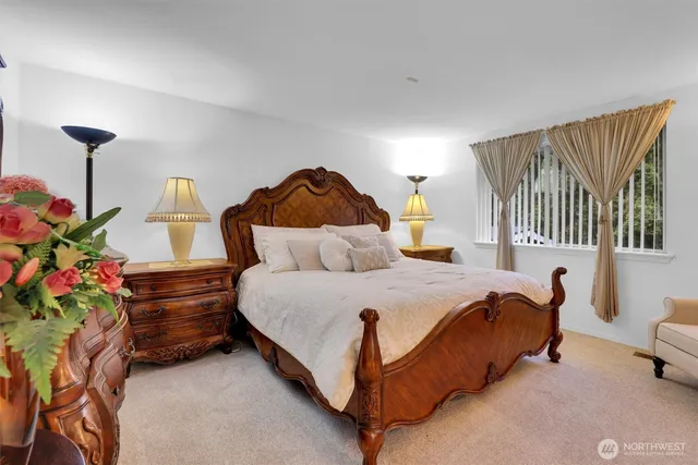 a spacious bedroom with a bed and a chandelier