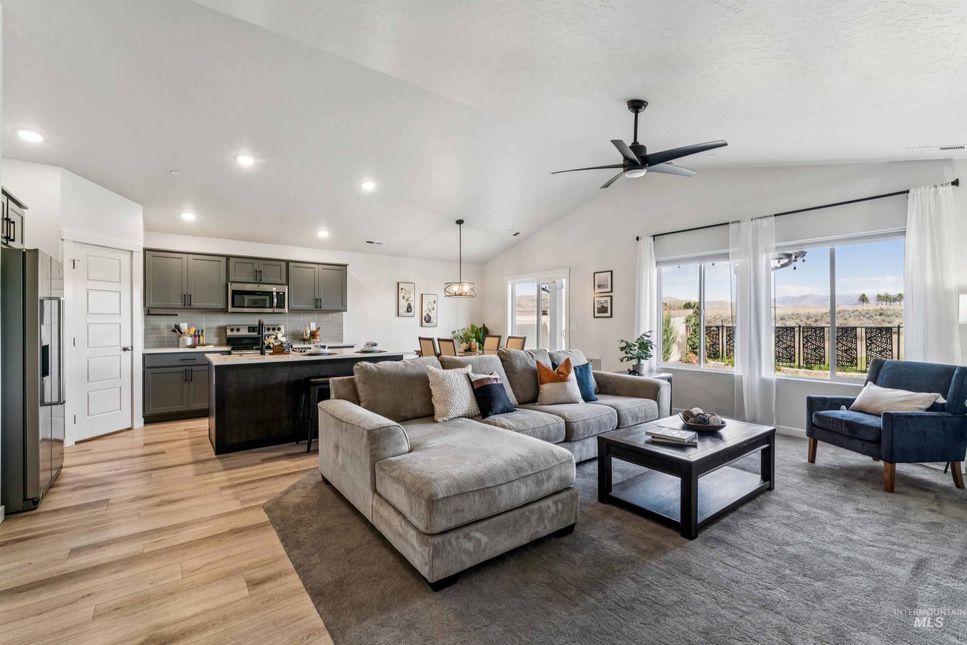 8386 South Bogus Rdg Avenue Boise, ID 83716 - Photo 15 of 50 Living area with light wood finished floors, lofted ceiling, a ceiling fan, and recessed lighting