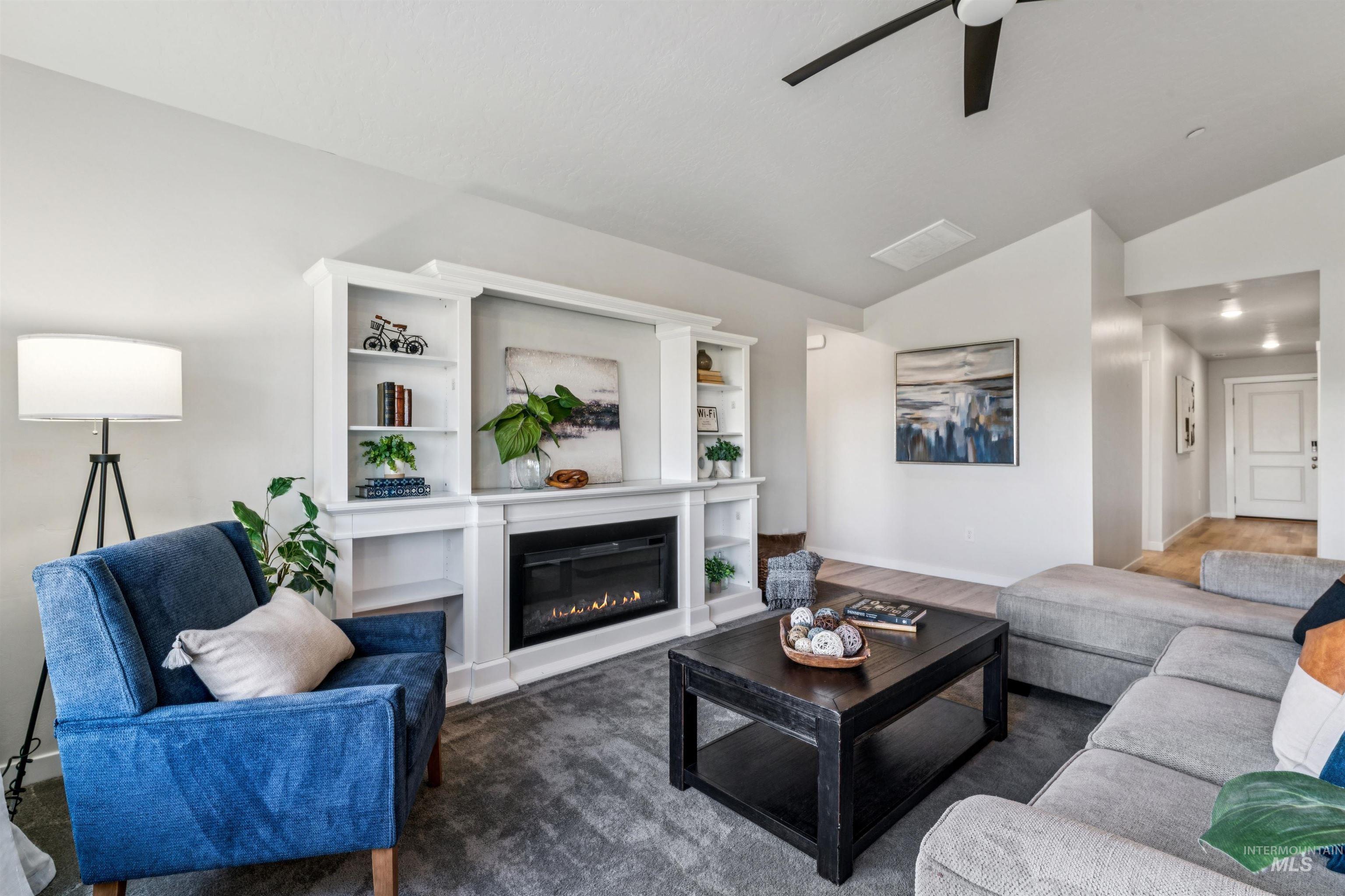 8386 South Bogus Rdg Avenue Boise, ID 83716 - Photo 17 of 50 Living area with vaulted ceiling, ceiling fan, and a glass covered fireplace