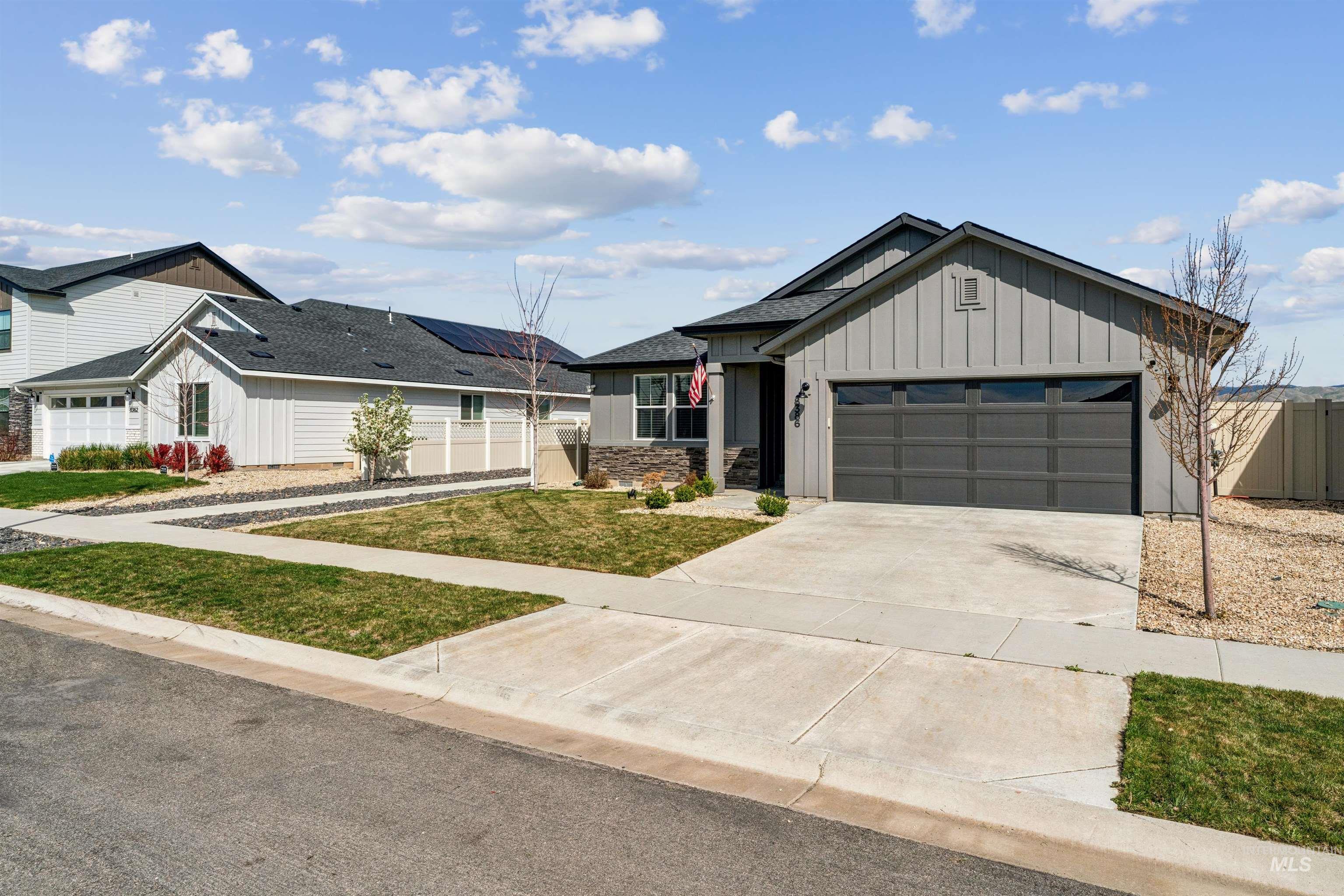 8386 South Bogus Rdg Avenue Boise, ID 83716 - Photo 47 of 50 View of front of property with board and batten siding, an attached garage, and concrete driveway