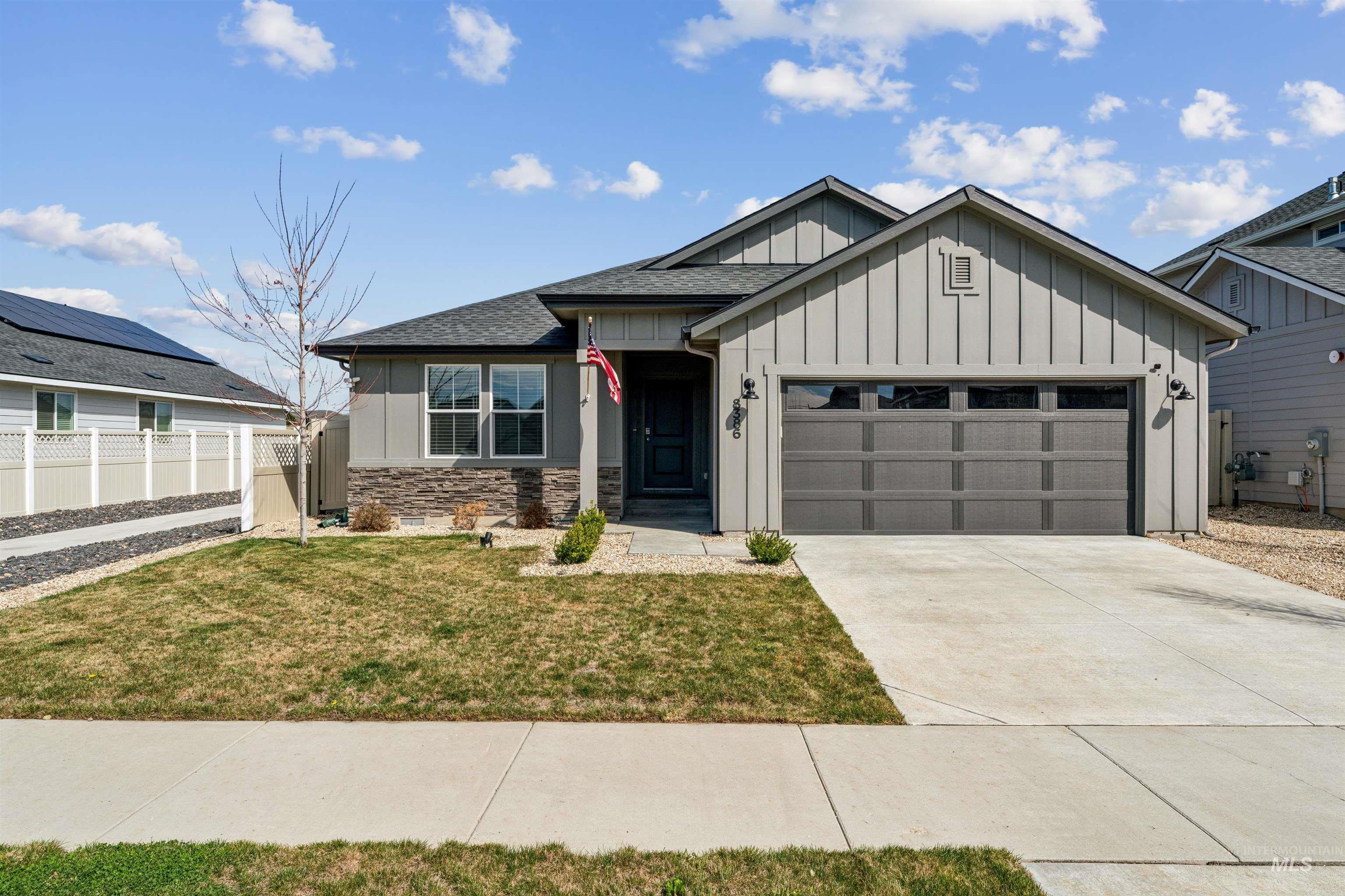 8386 South Bogus Rdg Avenue Boise, ID 83716 - Photo 48 of 50 View of front of home featuring board and batten siding, a garage, driveway, stone siding, and a shingled roof