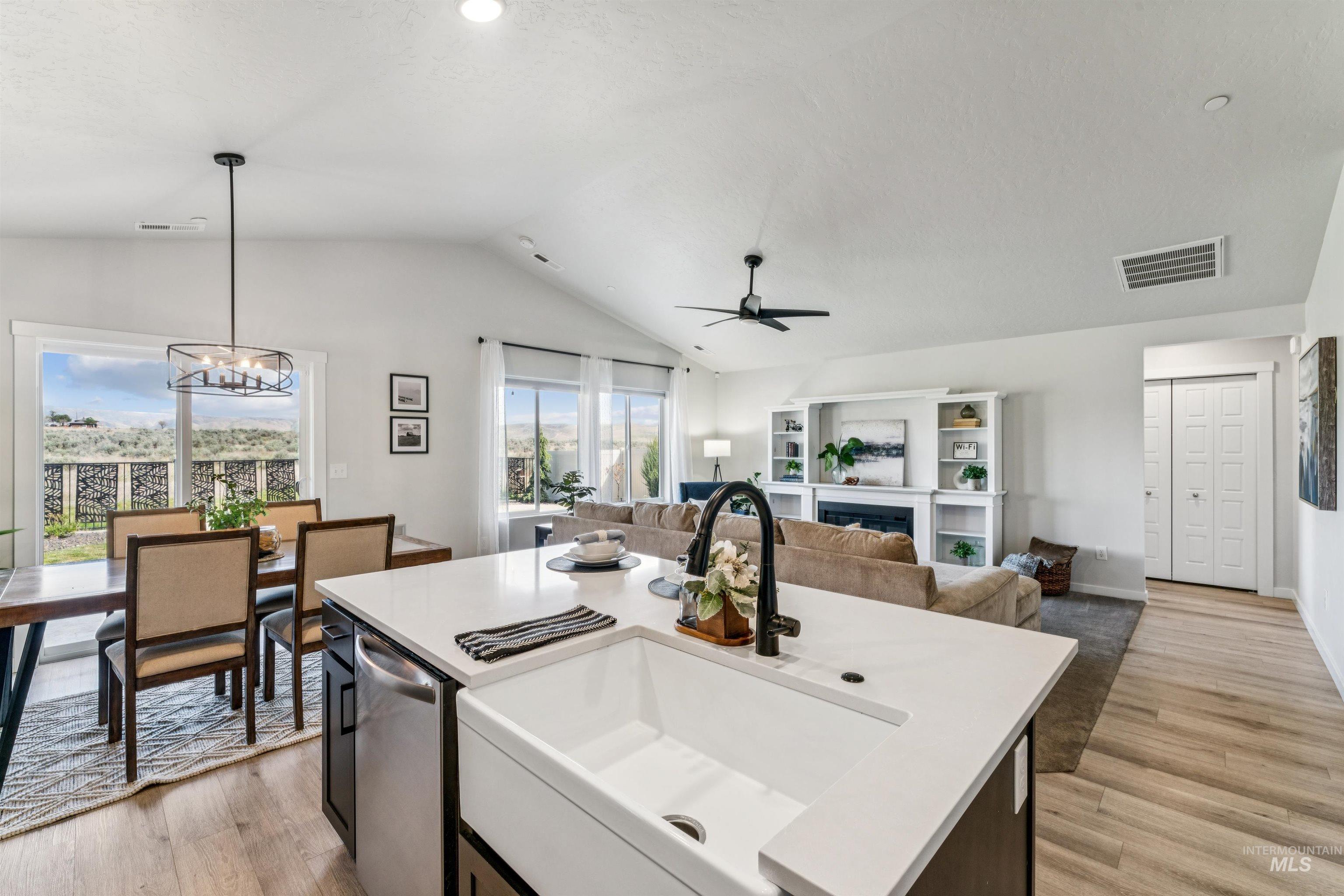 8386 South Bogus Rdg Avenue Boise, ID 83716 - Photo 50 of 50 Kitchen featuring open floor plan, ceiling fan, an island with sink, and light wood-style flooring