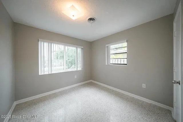 a view of a yard with palm trees