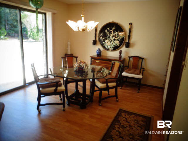 2804 Pine Ridge Drive Lillian, AL 36549 - Photo 10 of 39 13 x 11. Laminate wood look floor. Chandelier. Sliding door to patio. Door has a rolling storm shutter, 2013.