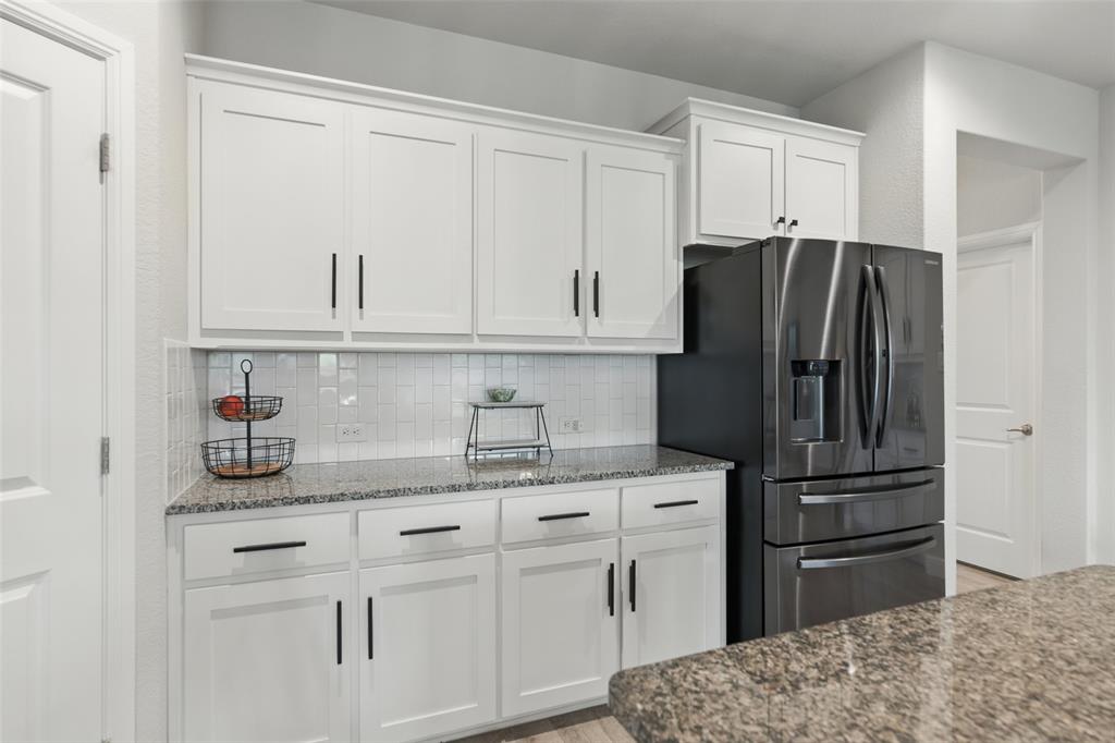 712 Finchley Drive Fort Worth, TX 76247 - Photo 11 of 37 a kitchen with stainless steel appliances granite countertop a refrigerator and a sink