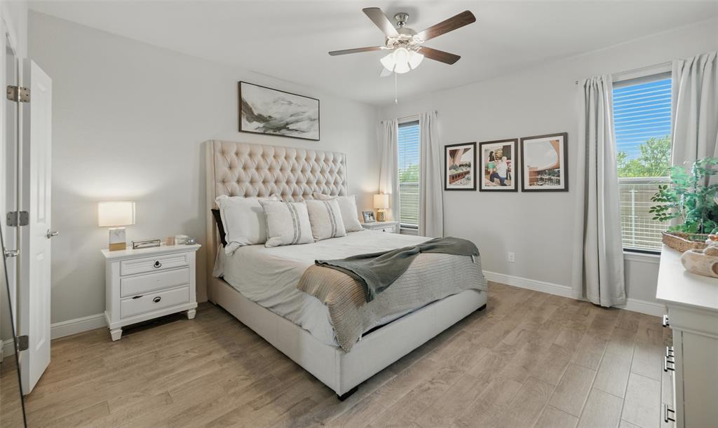 712 Finchley Drive Fort Worth, TX 76247 - Photo 20 of 37 a spacious bedroom with a bed and a painting on the wall