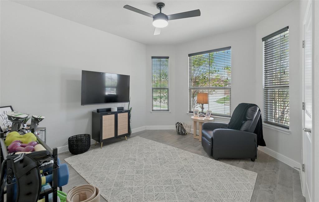 712 Finchley Drive Fort Worth, TX 76247 - Photo 25 of 37 a living room with furniture and a flat screen tv