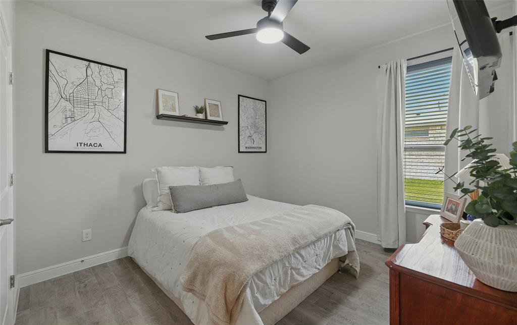 712 Finchley Drive Fort Worth, TX 76247 - Photo 26 of 37 a bedroom with a bed and a potted plant