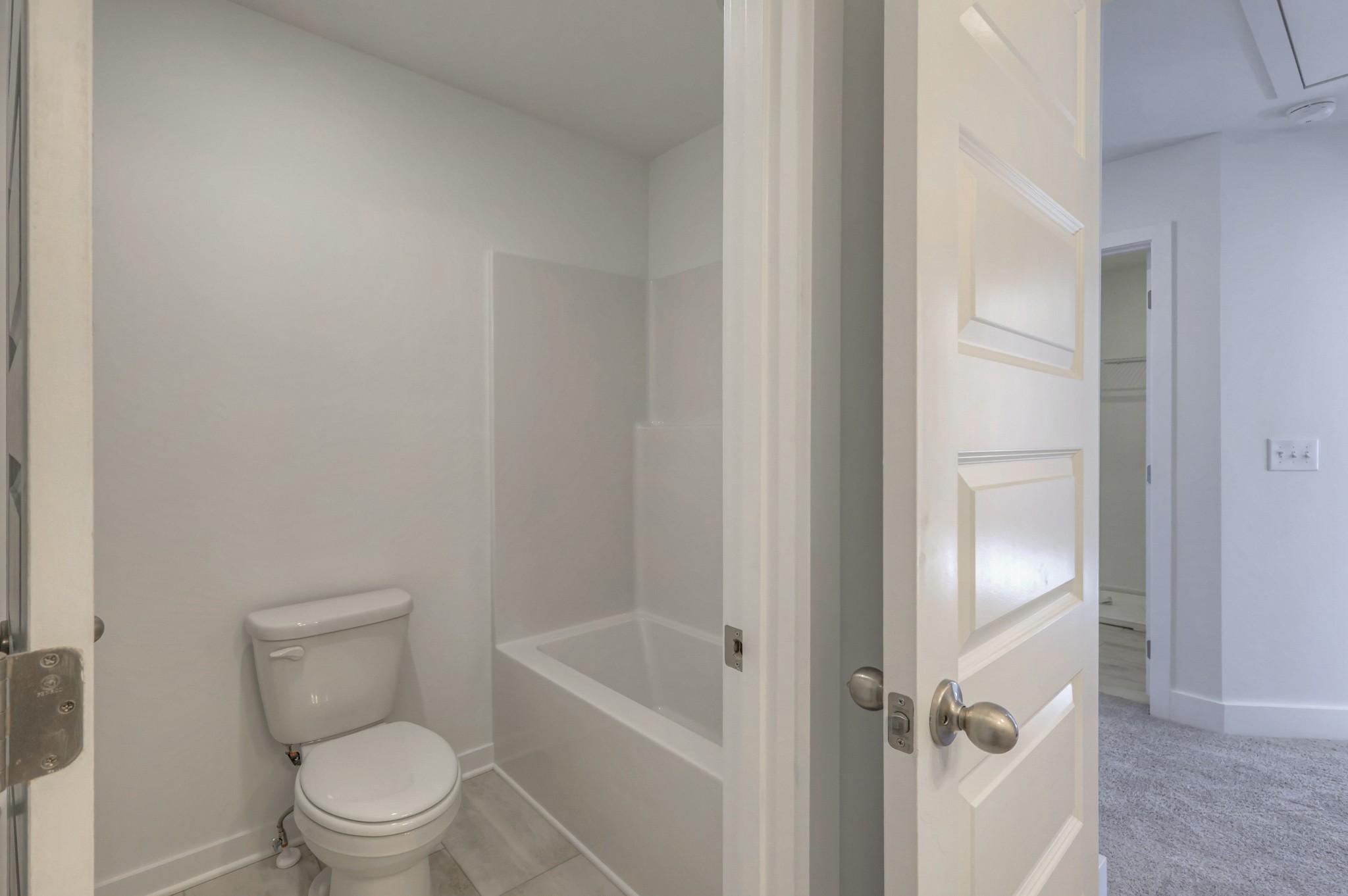 411 Duchess Boulevard, Unit A Gallatin, TN 37066 - Photo 21 of 26 a white toilet sitting next to a bathroom sink