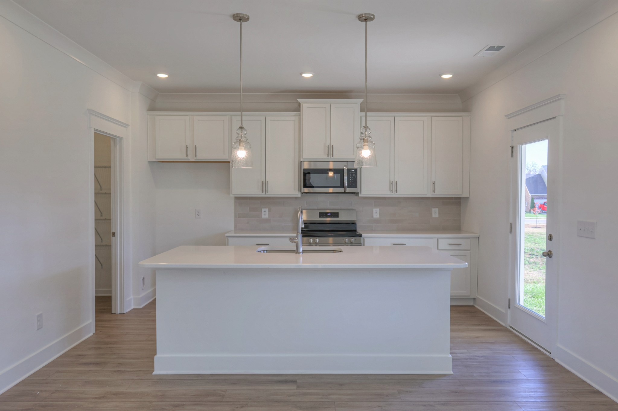411 Duchess Boulevard, Unit A Gallatin, TN 37066 - Photo 3 of 26 a large kitchen with stainless steel appliances granite countertop a sink a stove a refrigerator and island with wooden floor
