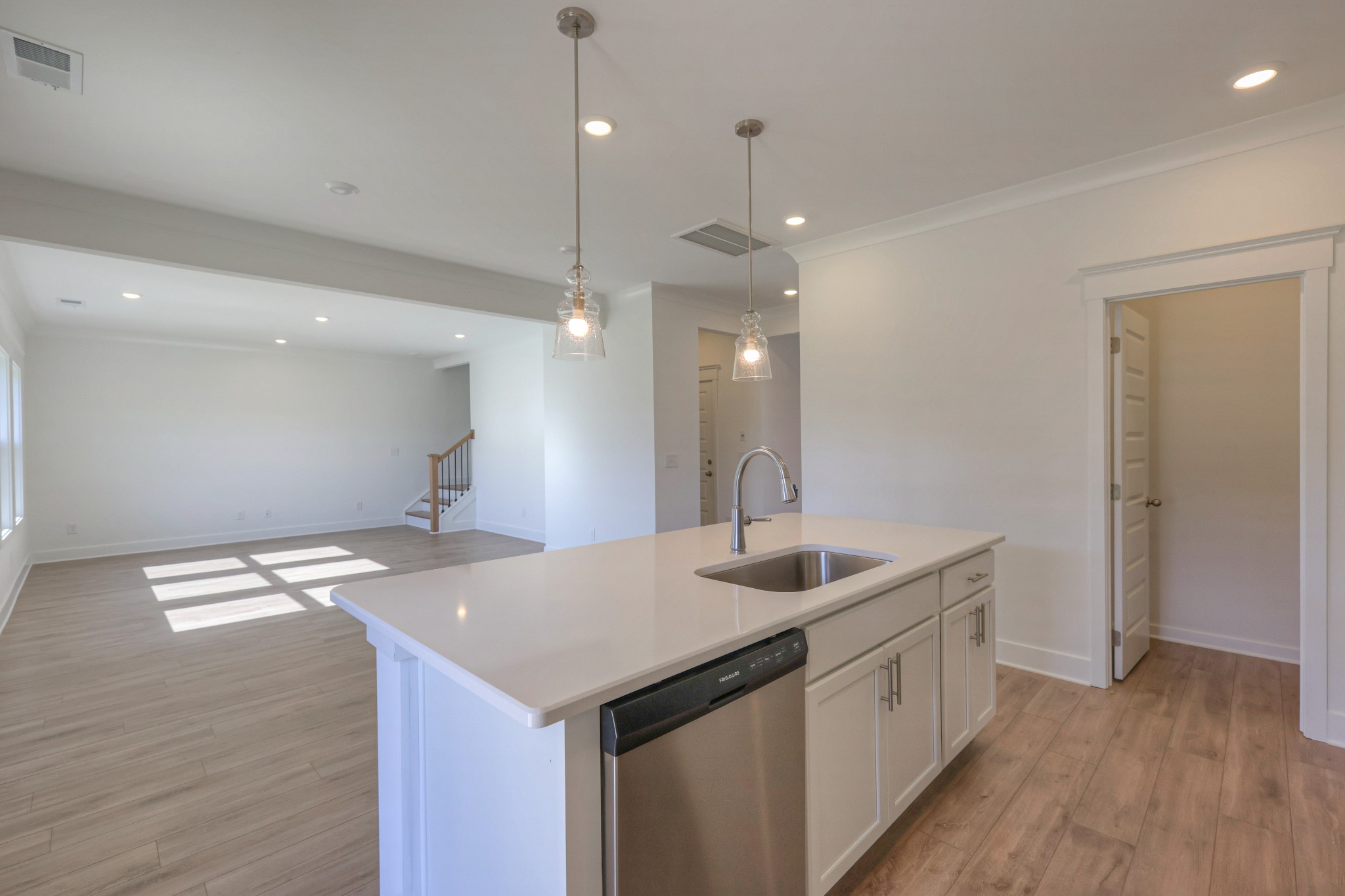 411 Duchess Boulevard, Unit A Gallatin, TN 37066 - Photo 6 of 26 a kitchen with a sink chandelier and wooden floor