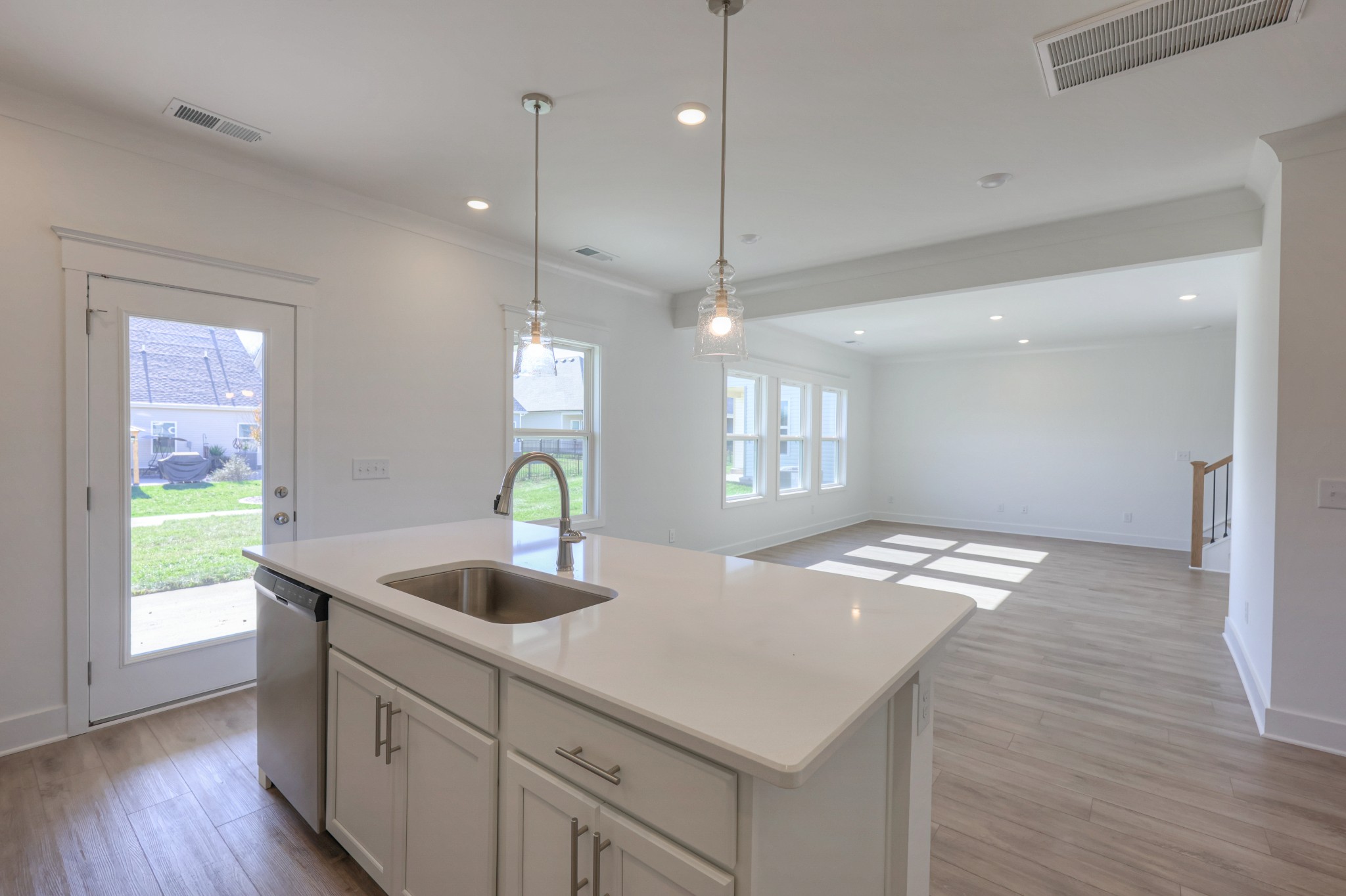 411 Duchess Boulevard, Unit A Gallatin, TN 37066 - Photo 7 of 26 a kitchen with granite countertop a sink a center island a wooden floor and a window
