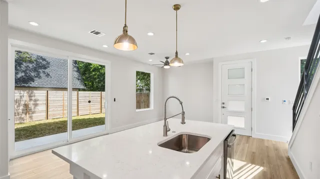 an empty room with a window and a ceiling fan