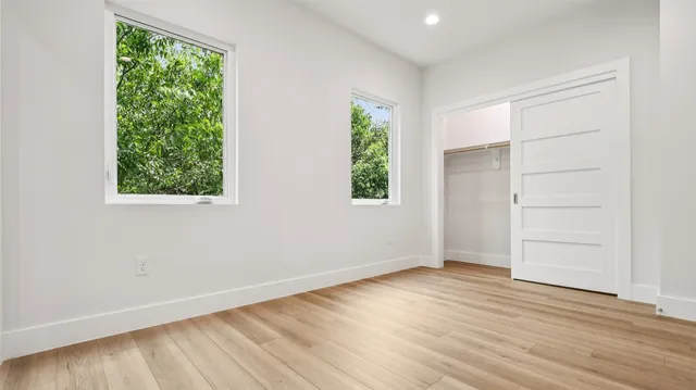an empty room with wooden floor