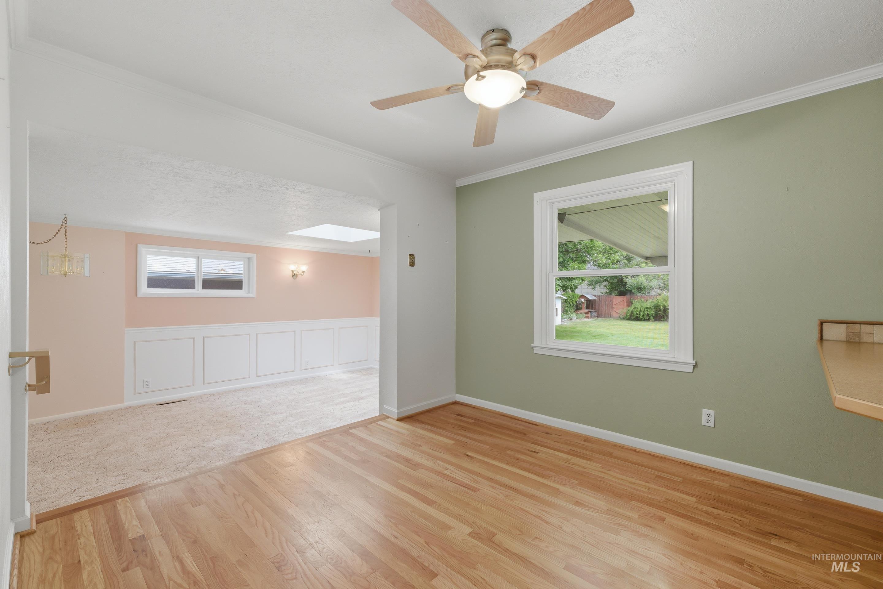 504 West Howe Street Boise, ID 83706 - Photo 15 of 47 Hardwood flooring in a room with a ceiling fan light fixture and a window providing natural light