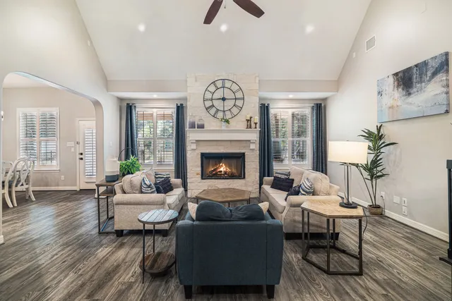 a living room with furniture a clock and a fireplace