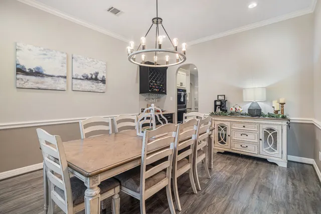 a view of a dining room with furniture wooden floor and chandelier