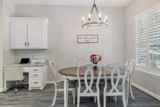a view of a dining room with furniture wooden floor and chandelier