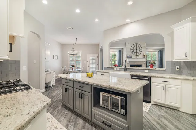 a kitchen with stainless steel appliances granite countertop a sink and cabinets