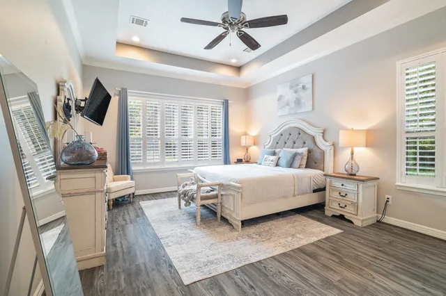 a bedroom with a bed a window and a chandelier