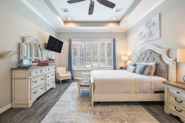 a bedroom with a bed and a chandelier