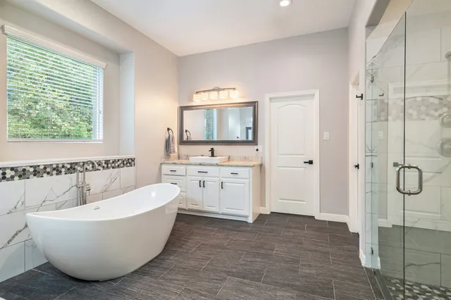 a bathroom with a bathtub and a shower