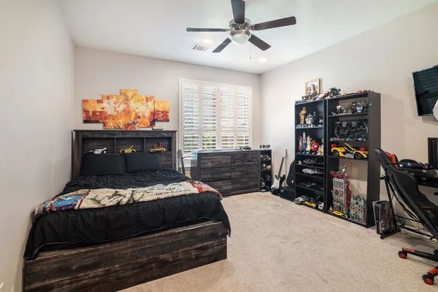 a bedroom with a bed closet and flat tv screen