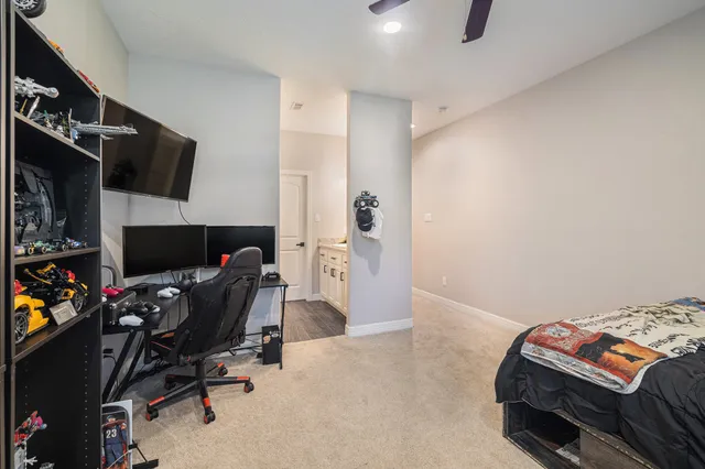 a bedroom with a bed and a tv