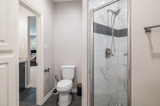 a bathroom with a toilet and a shower