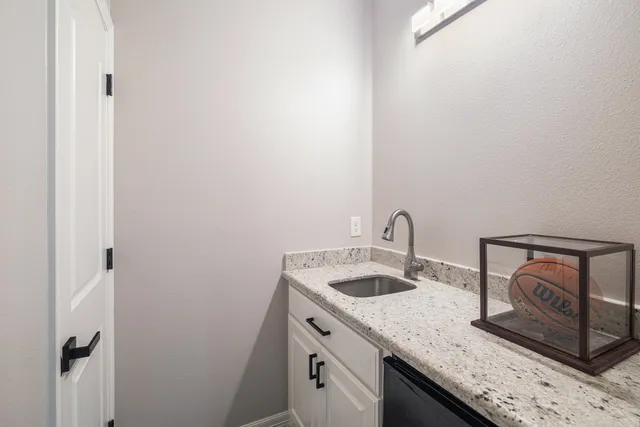 a bathroom with a granite countertop sink and vanity
