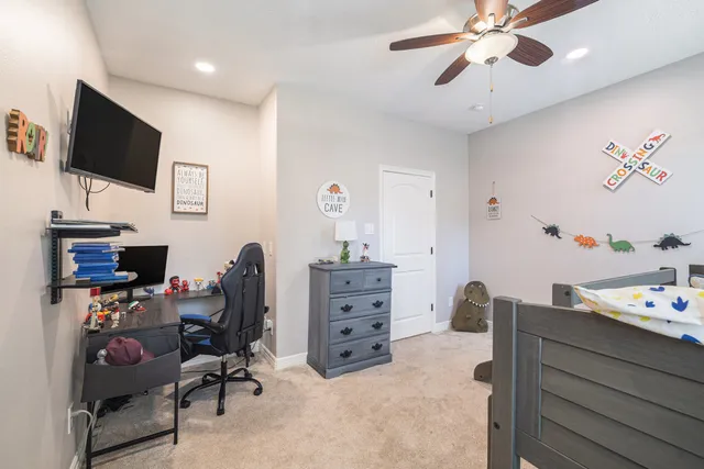 a view of a workspace with furniture and flat screen tv