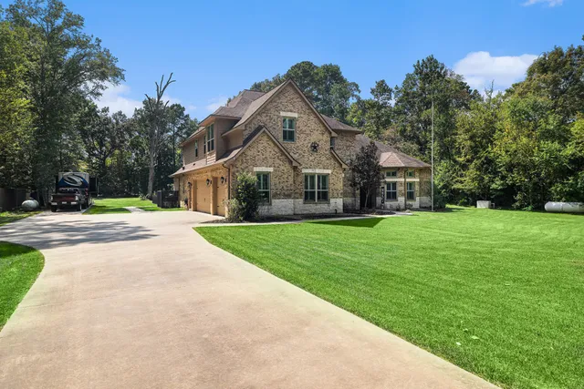 a front view of house with yard and green space