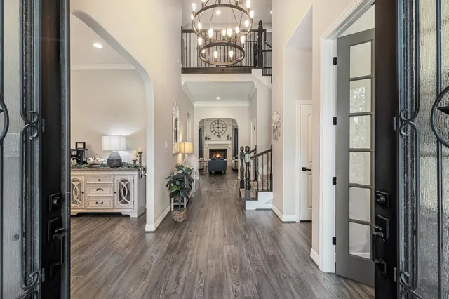 a hallway with view of living room and wooden floor