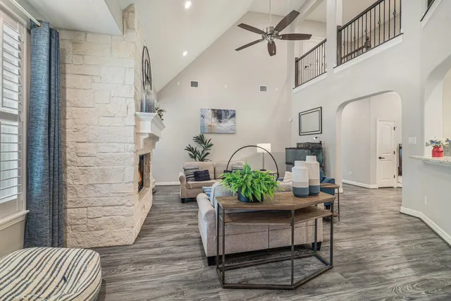 a living room with furniture and wooden floor