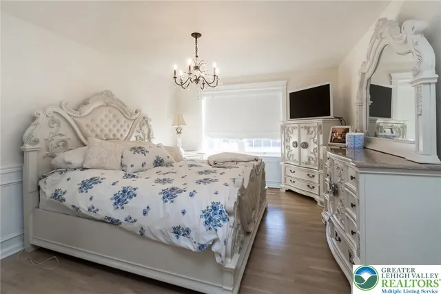 a view of a dining room with furniture and chandelier