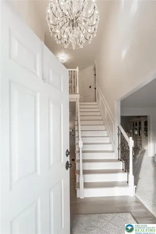 a kitchen with a sink a stove a refrigerator and white cabinets