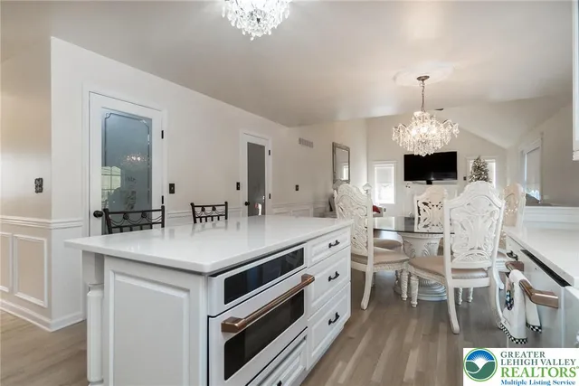 a bedroom with a chandelier and a dresser