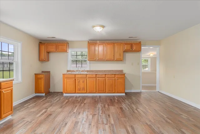 a view of a room with wooden floor and cabinet