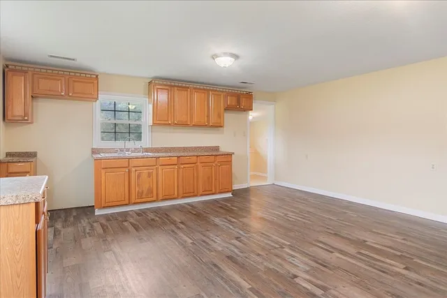 a view of a kitchen with wooden floor