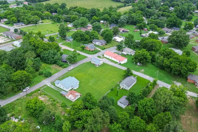 a backyard of a house with lots of trees