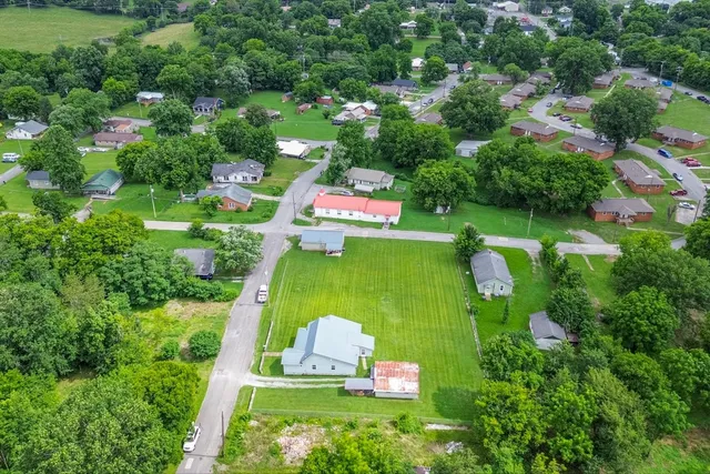 an aerial view of residential house with outdoor space and street view