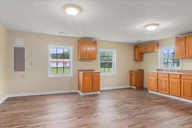 a view of a kitchen and a sink window an empty room