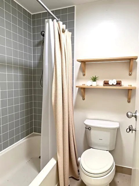 133 Commander Shea Boulevard, Unit 502 Quincy, MA 02171 - Photo 7 of 12 a white toilet sitting next to a bath tub