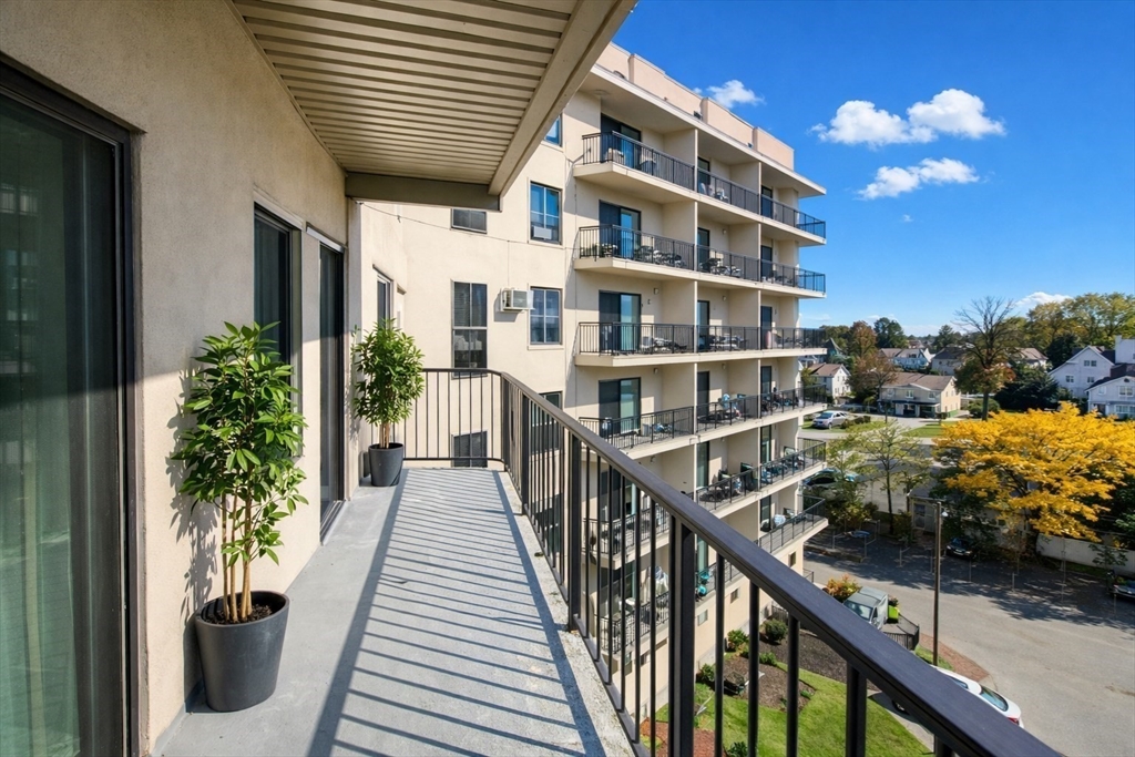 133 Commander Shea Boulevard, Unit 502 Quincy, MA 02171 - Photo 10 of 12 a view of a brick building from a balcony