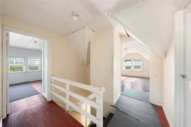 a view of a hallway with wooden floor and entryway